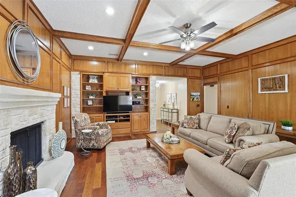 a living room with furniture a flat screen tv and a fireplace