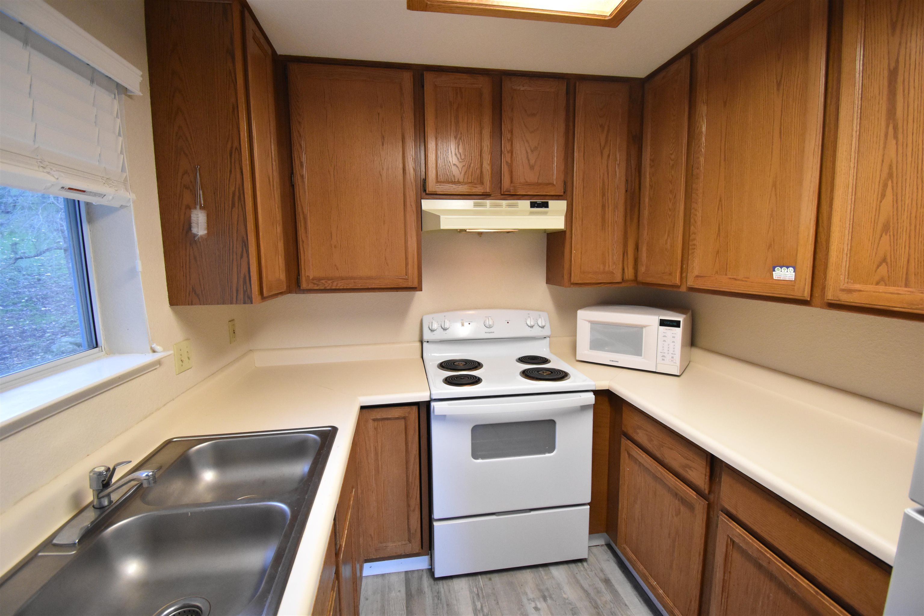 19283 James Circle Groveland, CA 95321 - Photo 15 of 40 a kitchen with a sink a stove and cabinets