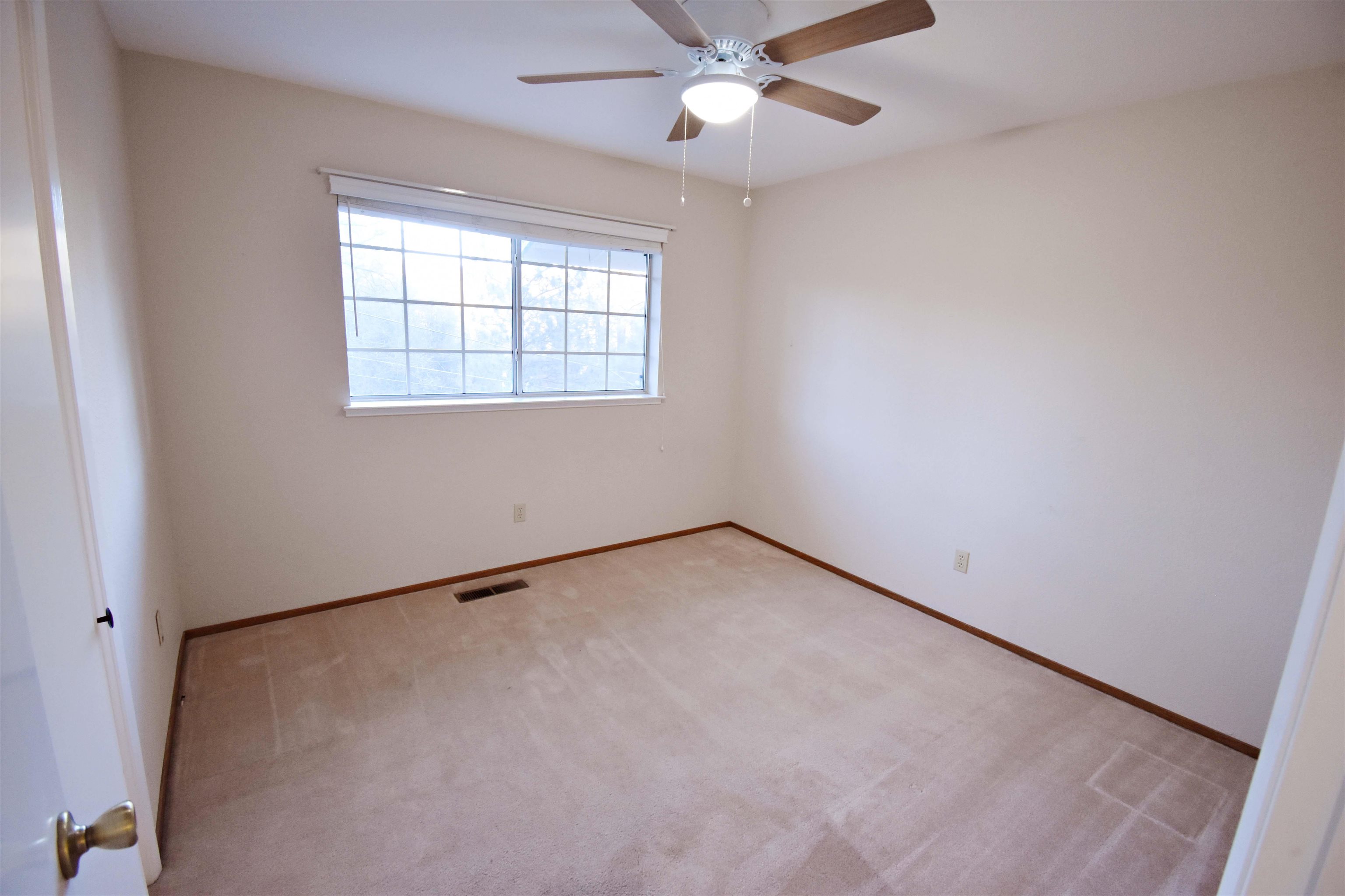 19283 James Circle Groveland, CA 95321 - Photo 18 of 40 an empty room with a window and a fan