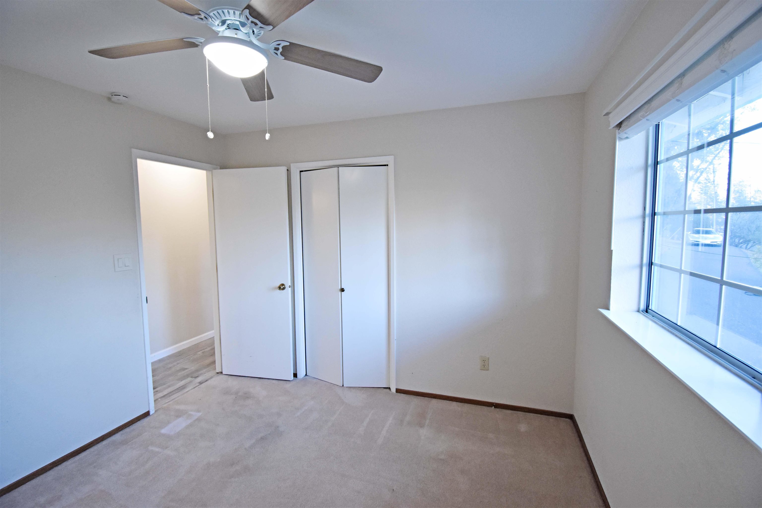 19283 James Circle Groveland, CA 95321 - Photo 19 of 40 an empty room with chandelier fan and windows