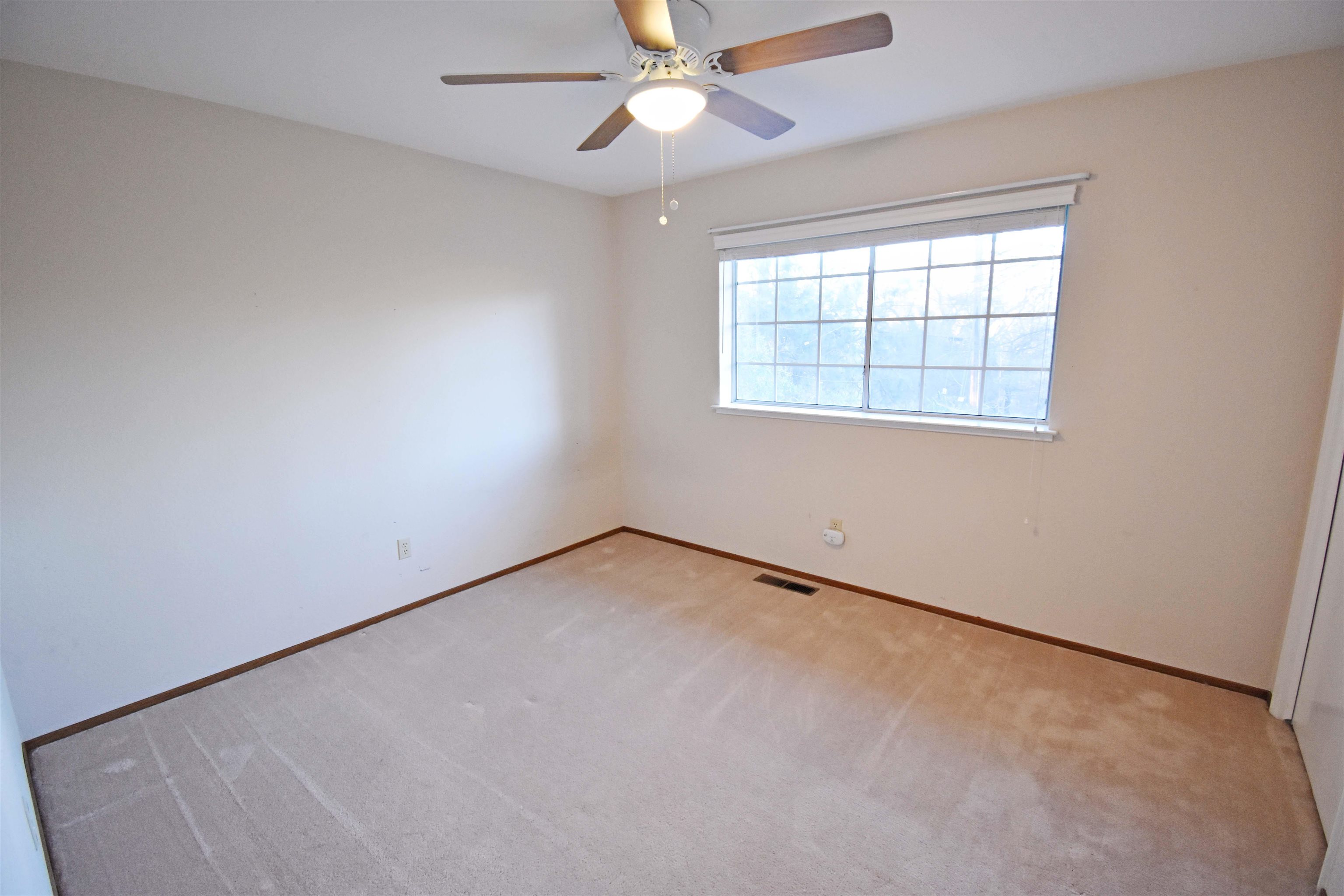19283 James Circle Groveland, CA 95321 - Photo 21 of 40 an empty room with a window and a fan