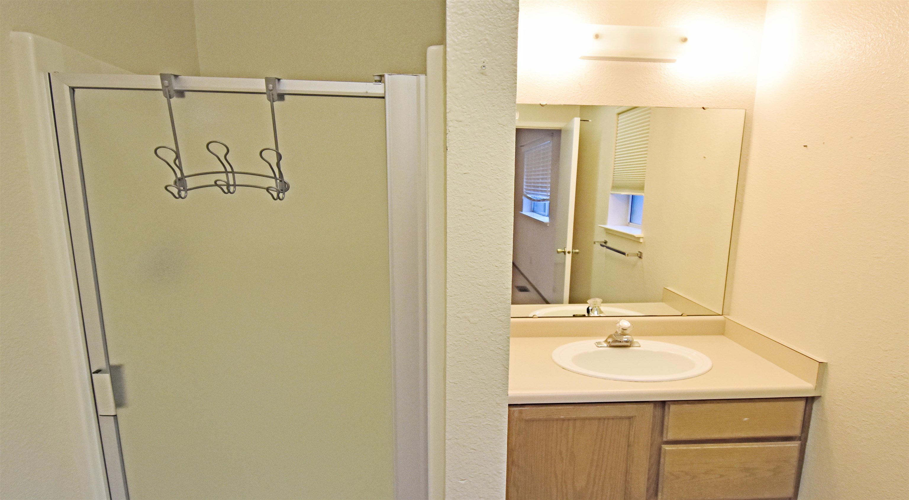 19283 James Circle Groveland, CA 95321 - Photo 28 of 40 a bathroom with a sink a shower and a mirror