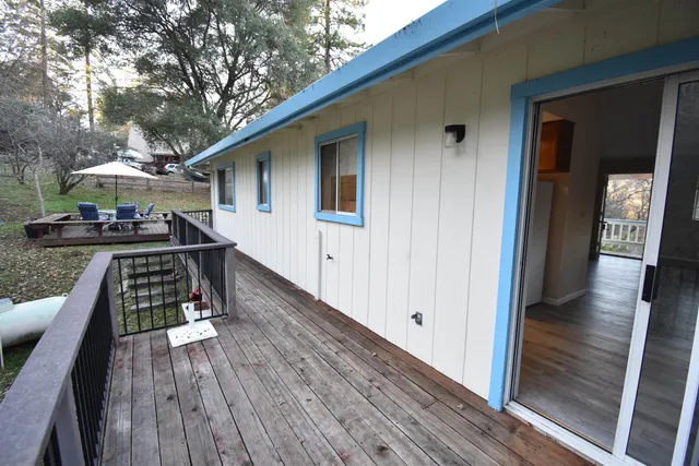 a view of a balcony with wooden floor