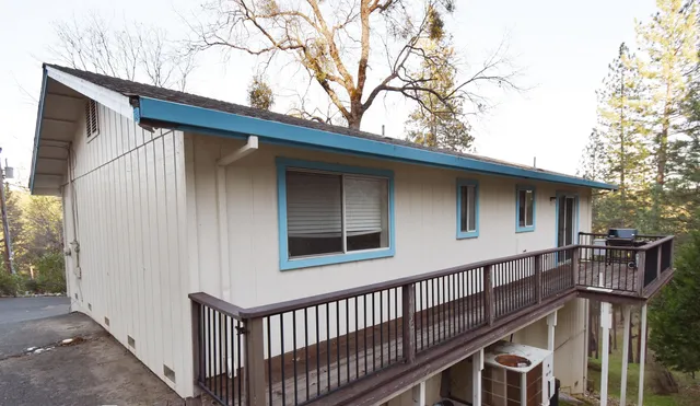 a view of a house with wooden fence
