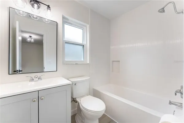 a bathroom with a sink a toilet and a bathtub