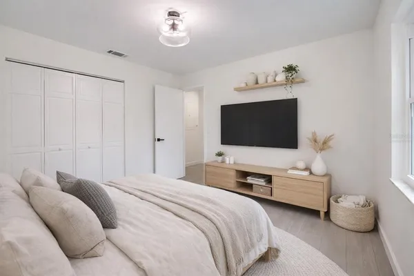 a bedroom with a bed and a flat screen tv
