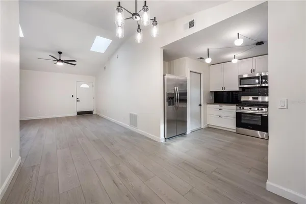 a view of a kitchen with wooden floor