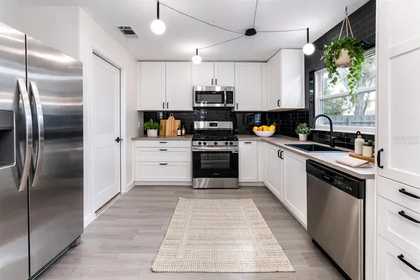a kitchen with a refrigerator a sink and dishwasher