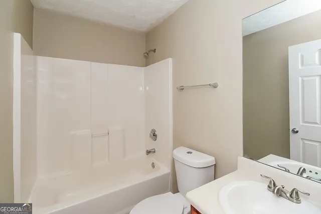 a bathroom with a toilet a sink and a bathtub