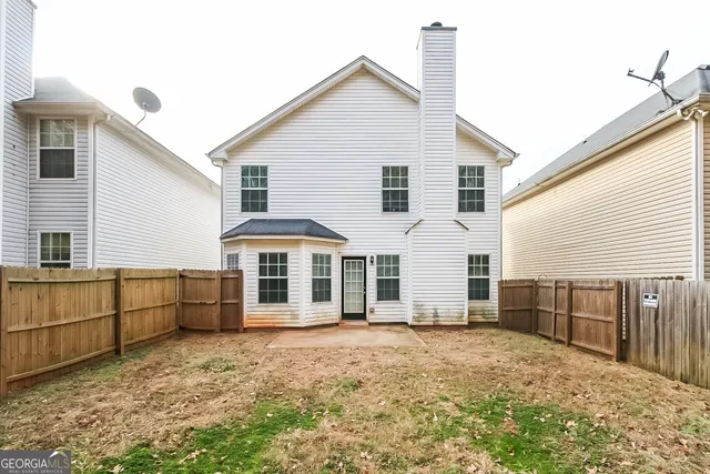 a view of a white house with large windows