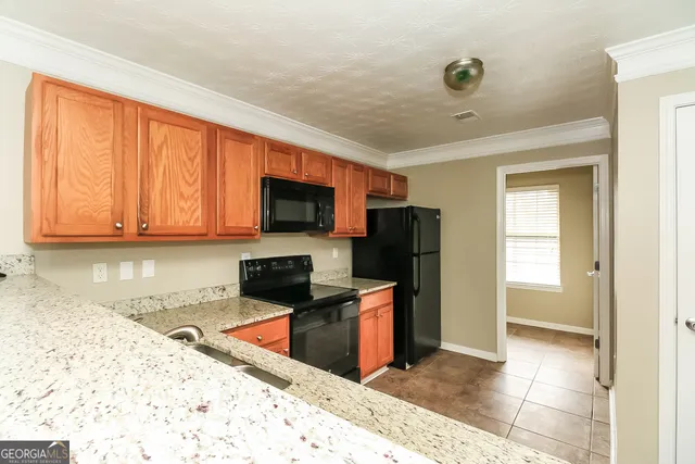 a kitchen with stainless steel appliances granite countertop a refrigerator and a sink