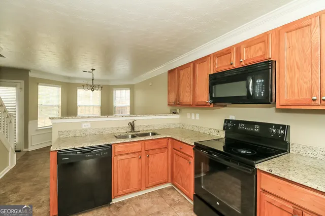 a kitchen with stainless steel appliances granite countertop a sink stove and microwave