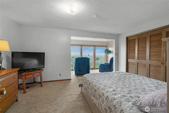 a bedroom with a large bed and a dresser