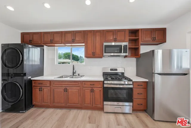 a kitchen with a stove a sink and a refrigerator