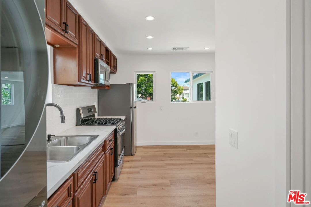 510 East Palmer Avenue Glendale, CA 91205 - Photo 20 of 26 a kitchen with stainless steel appliances granite countertop a sink and a stove