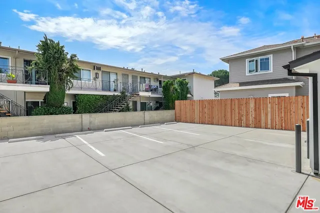 a view of a house with wooden fence