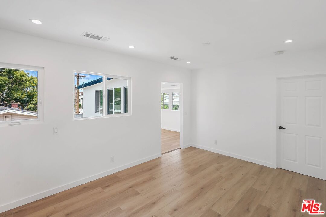 510 East Palmer Avenue Glendale, CA 91205 - Photo 9 of 26 an empty room with wooden floor and windows