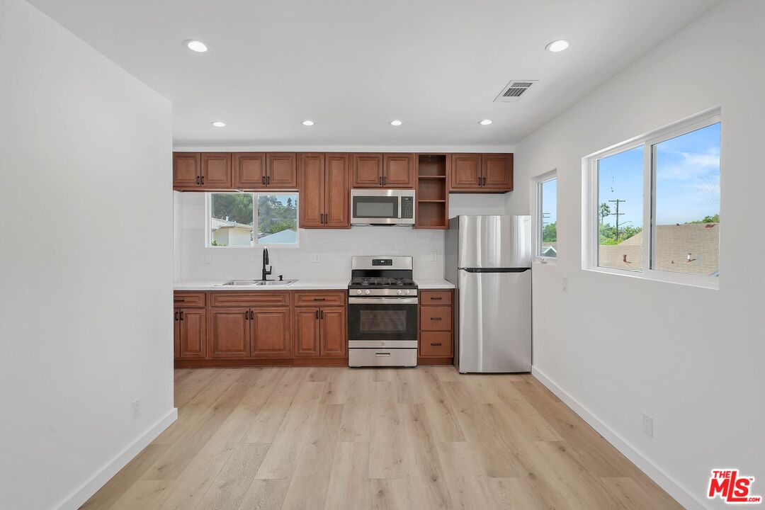 510 East Palmer Avenue Glendale, CA 91205 - Photo 10 of 26 a kitchen with stainless steel appliances granite countertop a stove a sink and a refrigerator