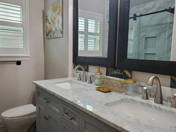 a bedroom with a bed and large windows