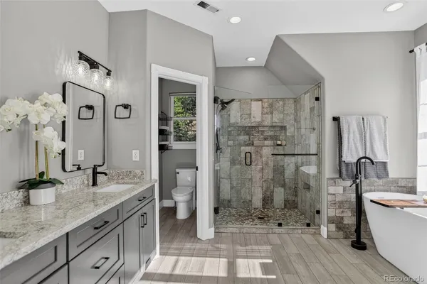 a bath tub sitting in a bathroom next to a window