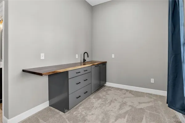 a room with pool table and windows