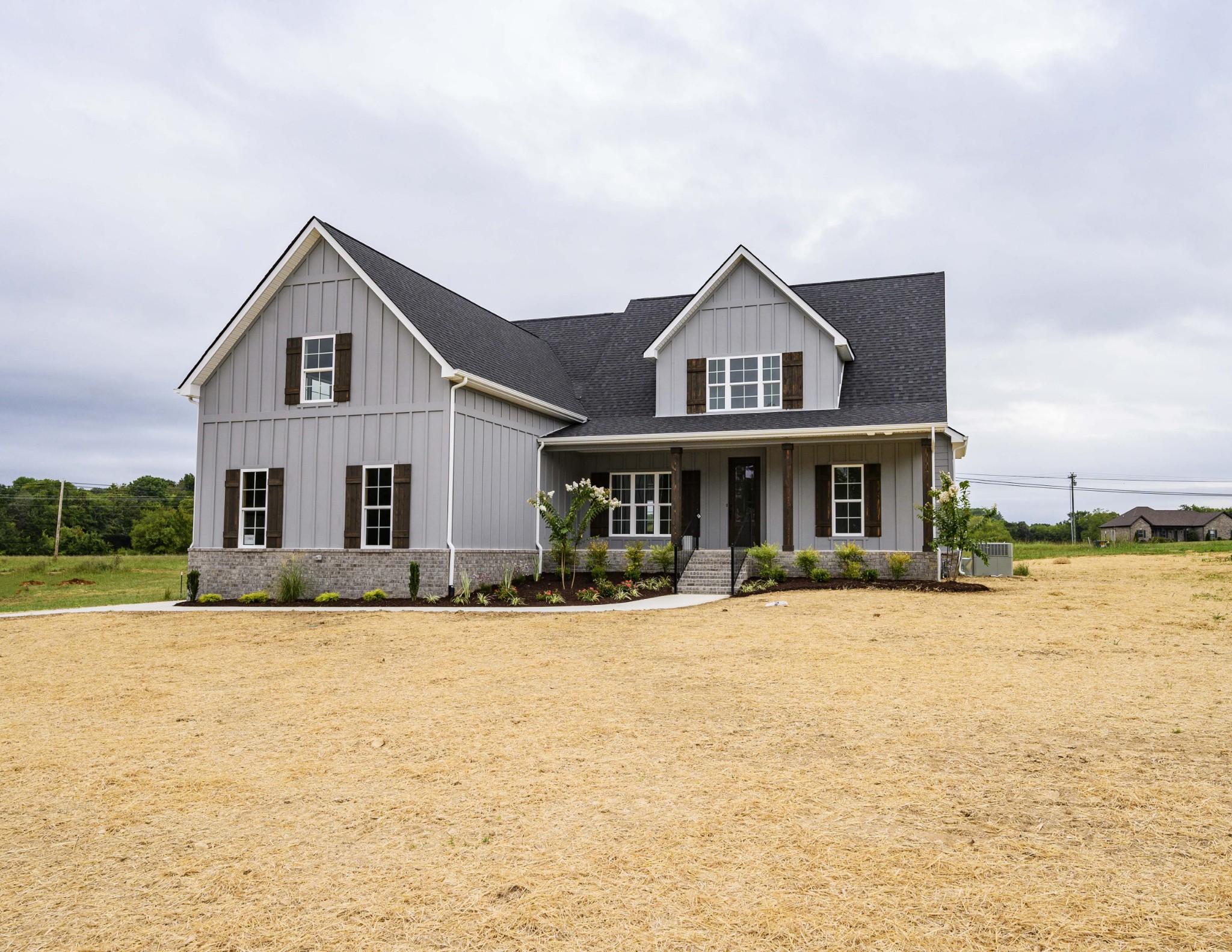 a front view of house with yard and car parked