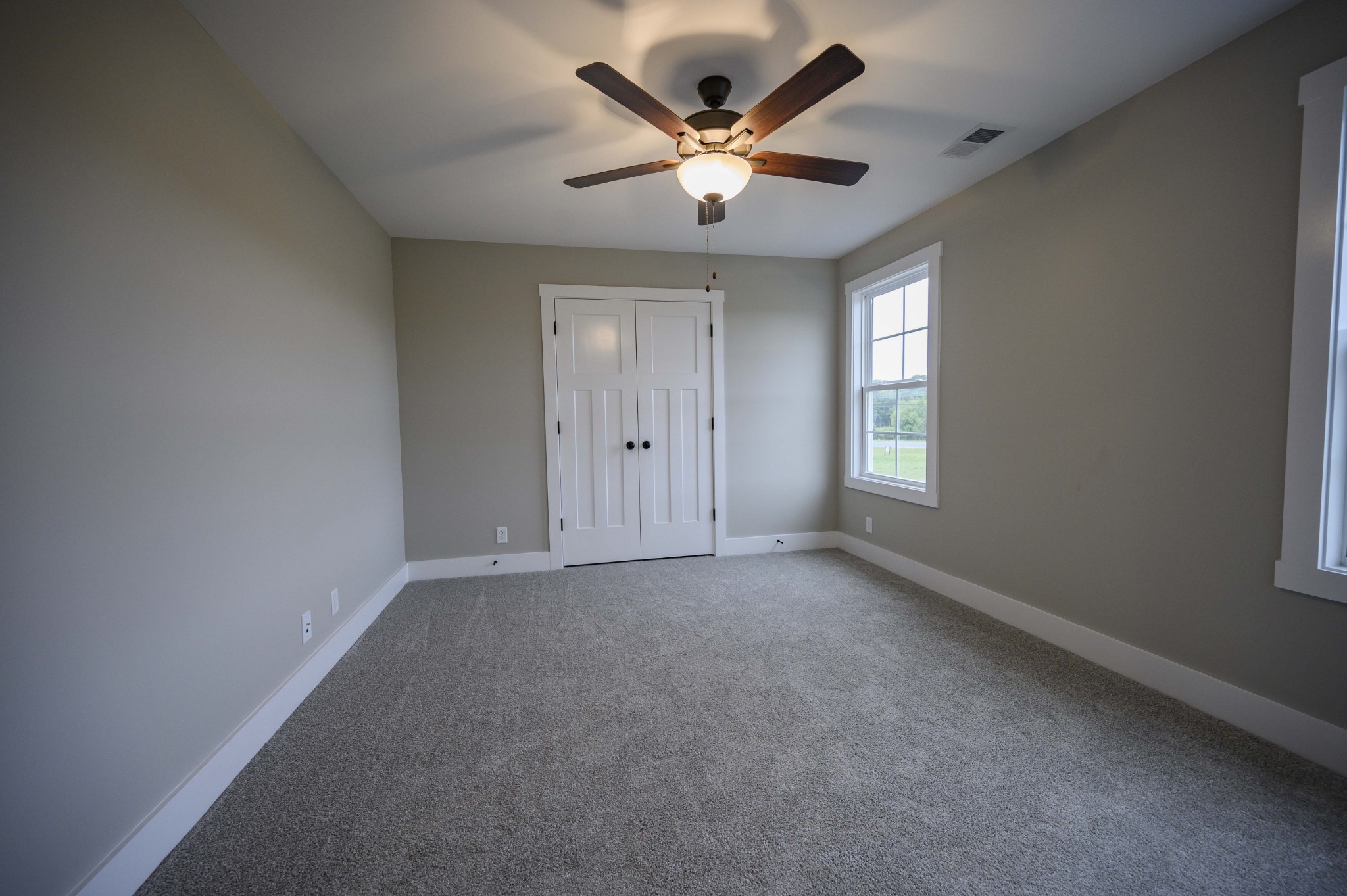 11801 North Milton Road Milton, TN 37118 - Photo 42 of 48 an empty room with a ceiling fan and window