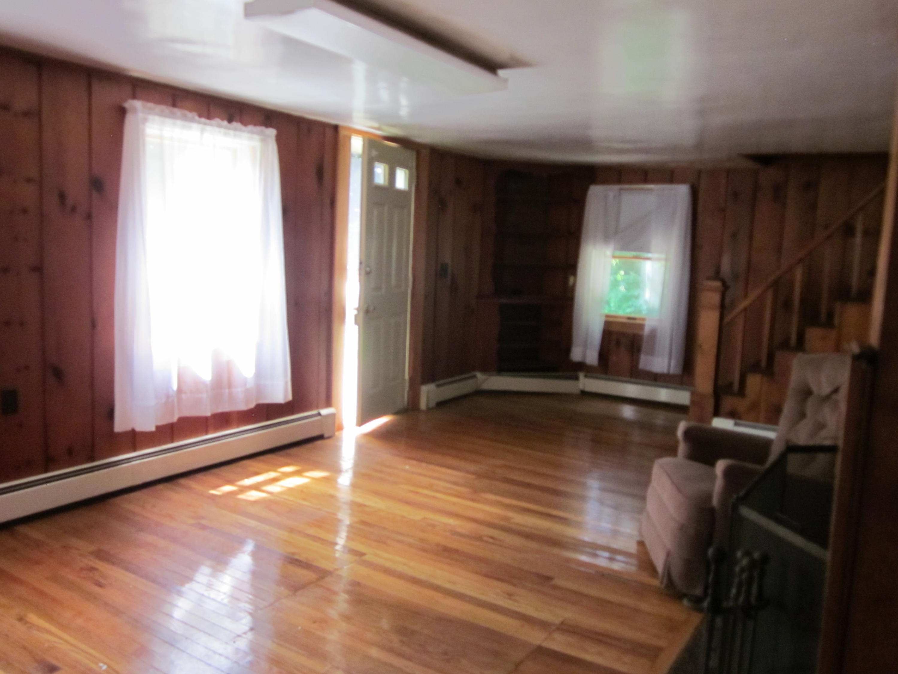 81 Shore Road Truro, MA 02666 - Photo 2 of 11 a view of an empty room with wooden floor and a window
