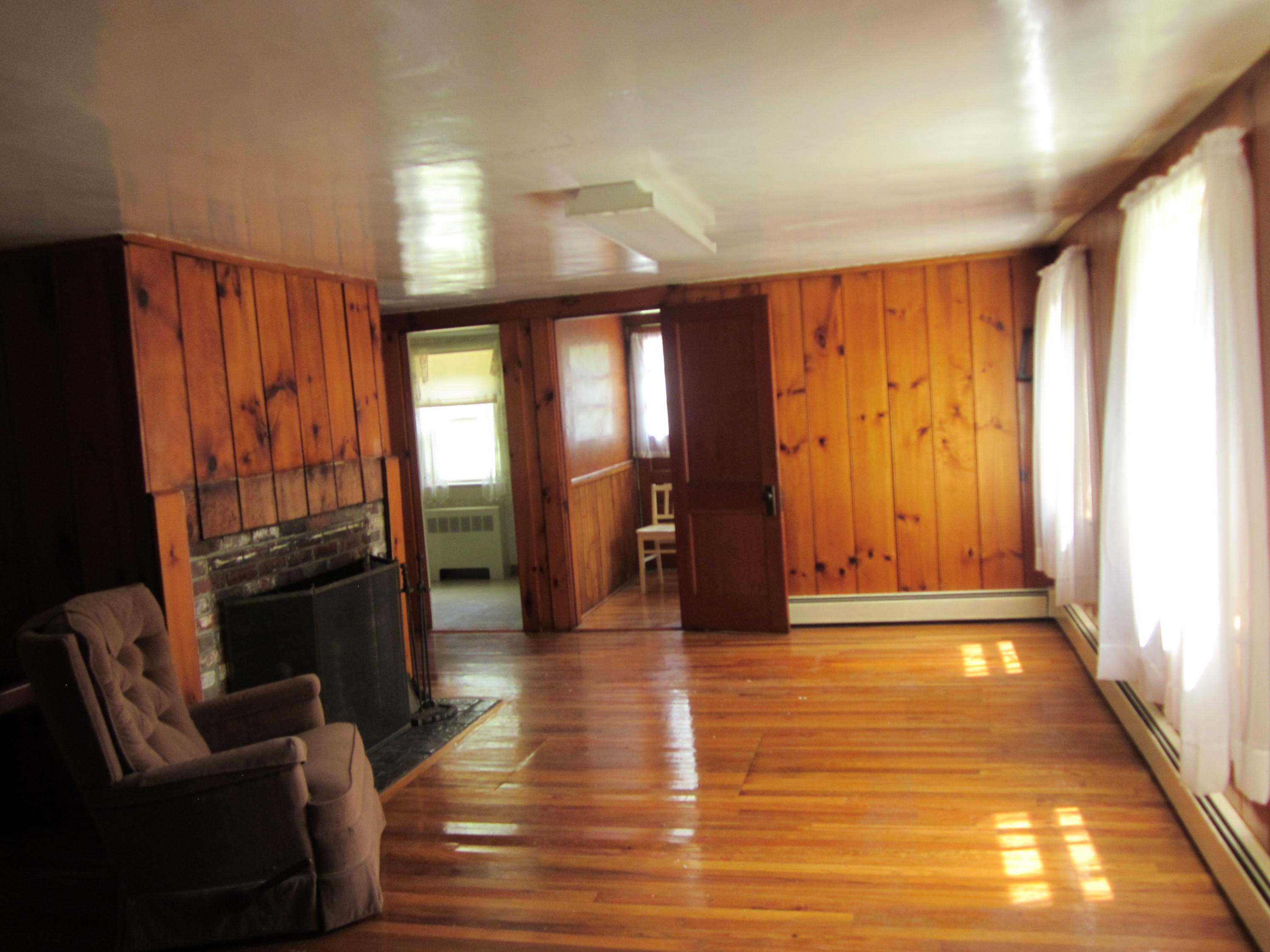 81 Shore Road Truro, MA 02666 - Photo 3 of 11 a view of an empty room with wooden floor and a window