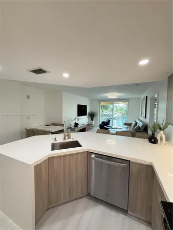 a kitchen with sink and white cabinets