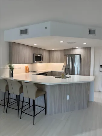 a kitchen with a table chairs sink and cabinets