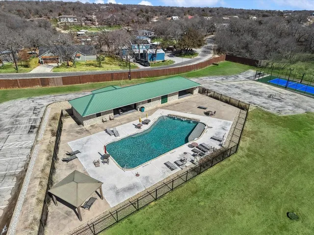 an aerial view of a house with a big yard