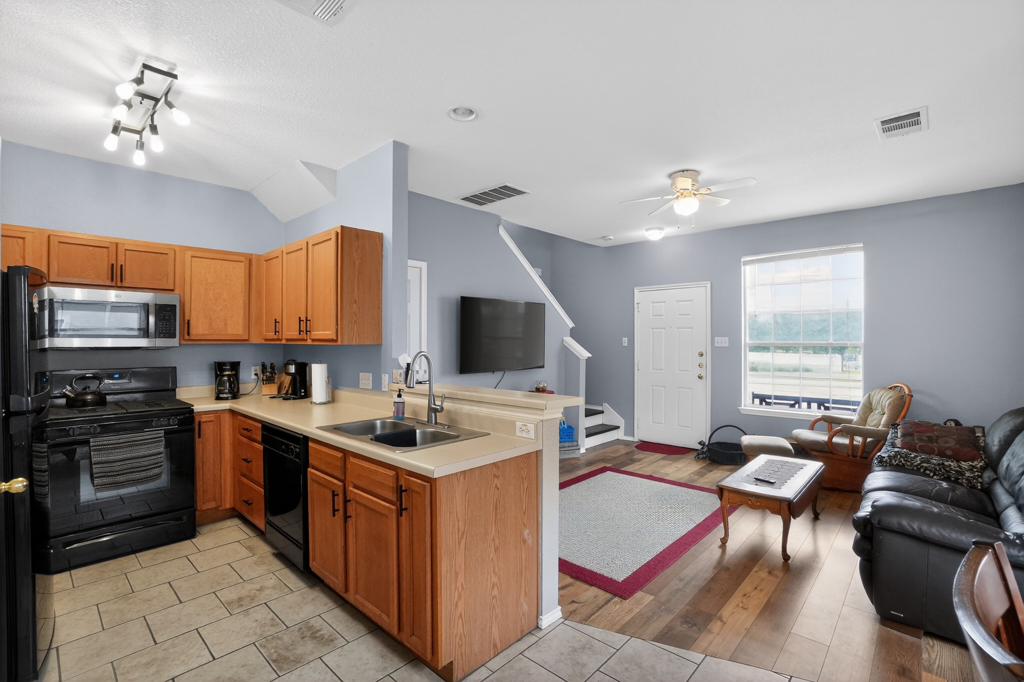 13808 Harris Ridge Boulevard Pflugerville, TX 78660 - Photo 14 of 40 a kitchen with a stove a sink and a refrigerator