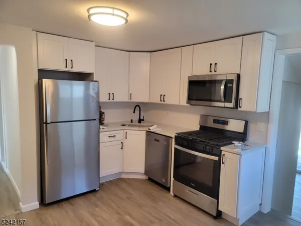 a kitchen with a refrigerator stove and microwave