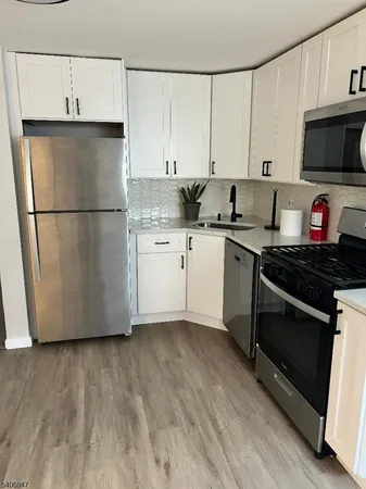 a kitchen with stainless steel appliances a stove a microwave and a refrigerator