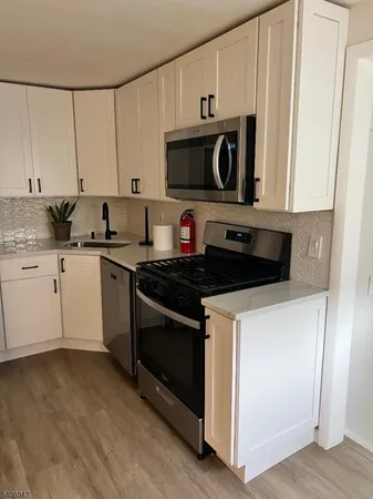 a kitchen with stainless steel appliances a stove a microwave and cabinets