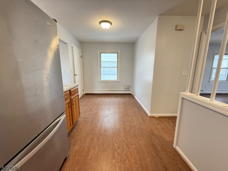 50 Buschmann Avenue, Unit 2 Haledon, NJ 07508 - Photo 5 of 11 wooden floor in an empty room with a window