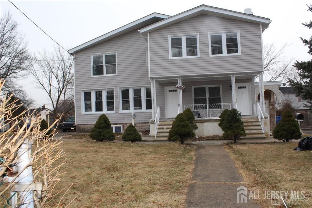 899 Green Street, Unit 1ST F Iselin, NJ 08830 - Photo 2 of 8 a front view of a house with a garden