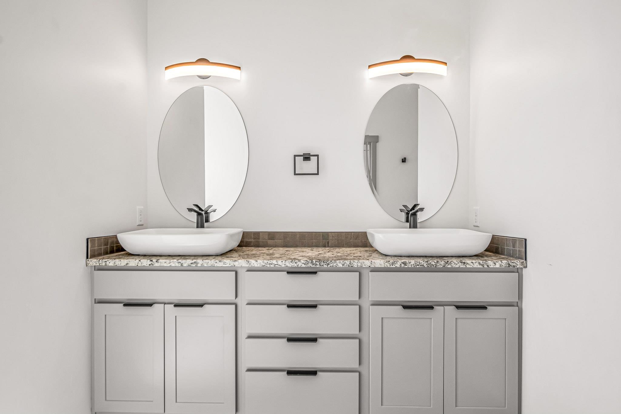 3087 Thunder Cloud Drive Grand Junction, CO 81504 - Photo 15 of 33 a bathroom with a granite countertop sink and a mirror