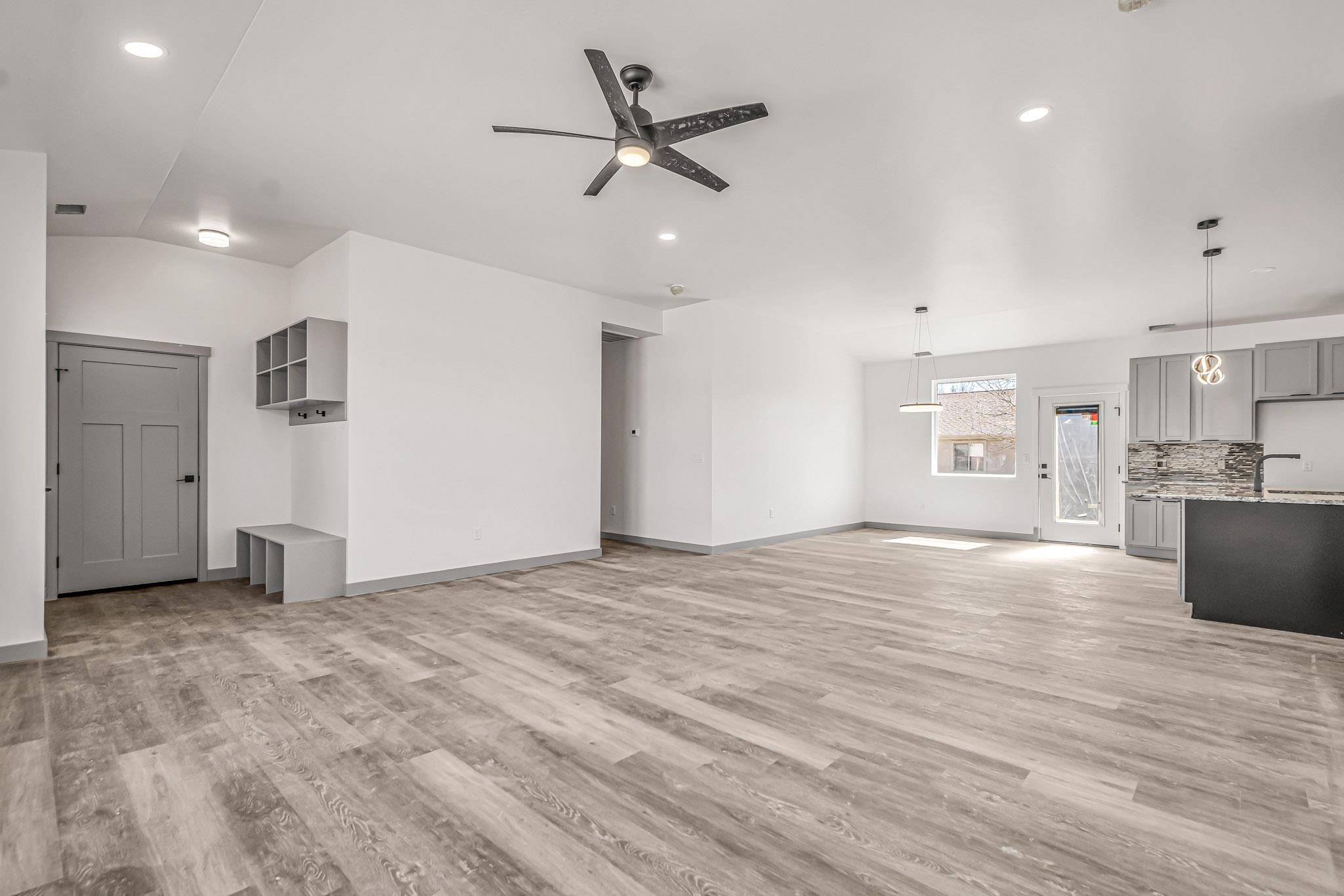 3087 Thunder Cloud Drive Grand Junction, CO 81504 - Photo 4 of 33 a view of an empty room and kitchen view with wooden floor