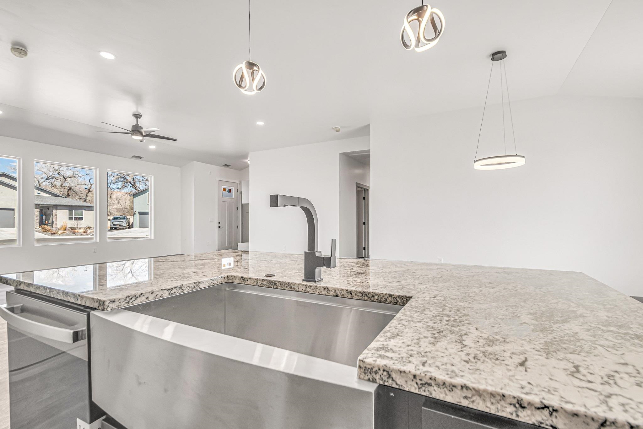 3087 Thunder Cloud Drive Grand Junction, CO 81504 - Photo 10 of 33 a view of a kitchen with kitchen island a sink and a counter top space