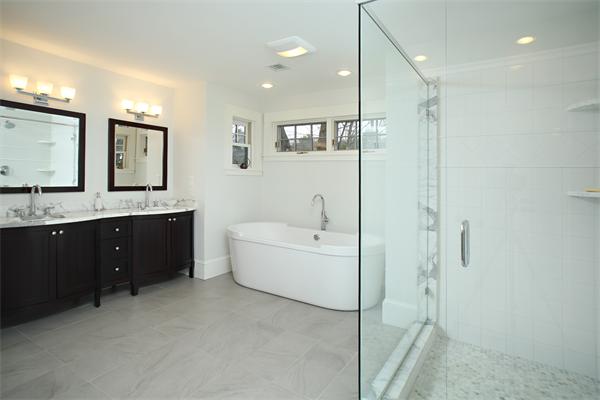 73 Oak Cliff Road Newton, MA 02460 - Photo 9 of 10 a bathroom with a granite countertop sink mirror and bathtub