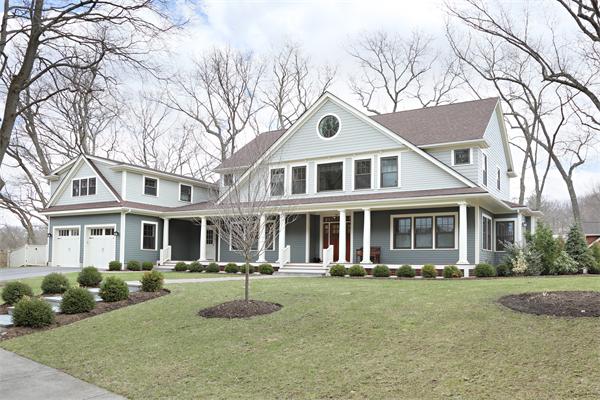73 Oak Cliff Road Newton, MA 02460 - Photo 10 of 10 a front view of a house with a yard and garage