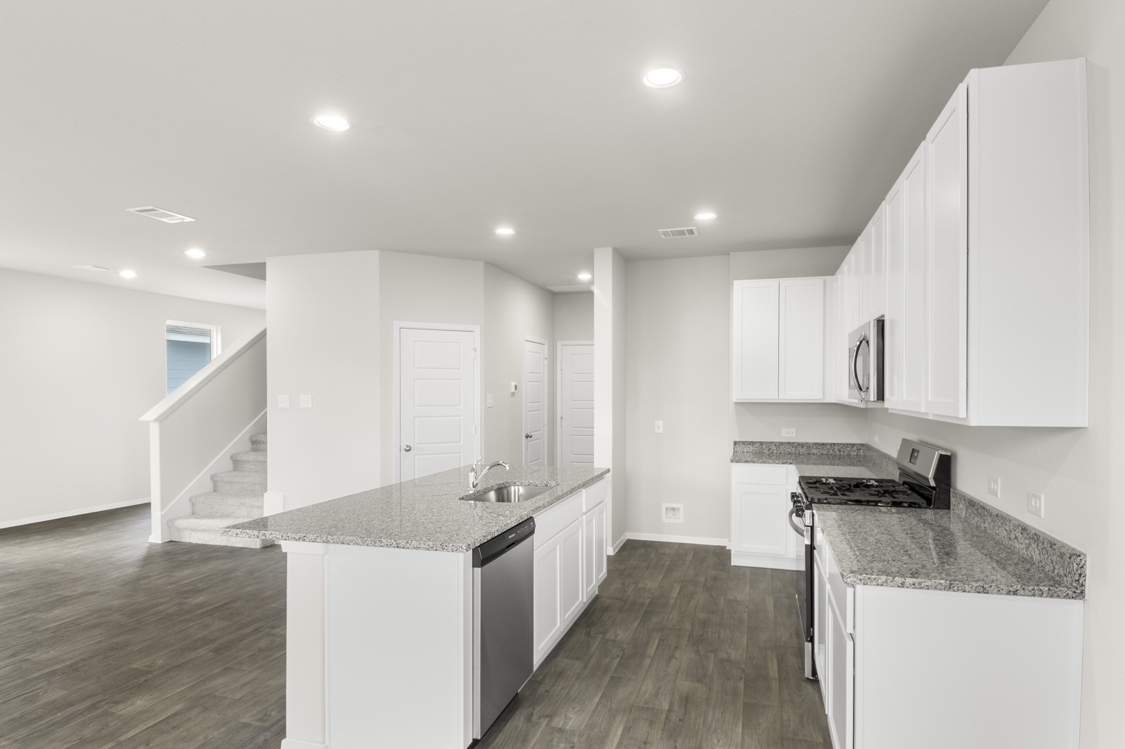 305 Jade Street Maxwell, TX 78656 - Photo 12 of 32 a large kitchen with stainless steel appliances granite countertop a sink a stove and a refrigerator