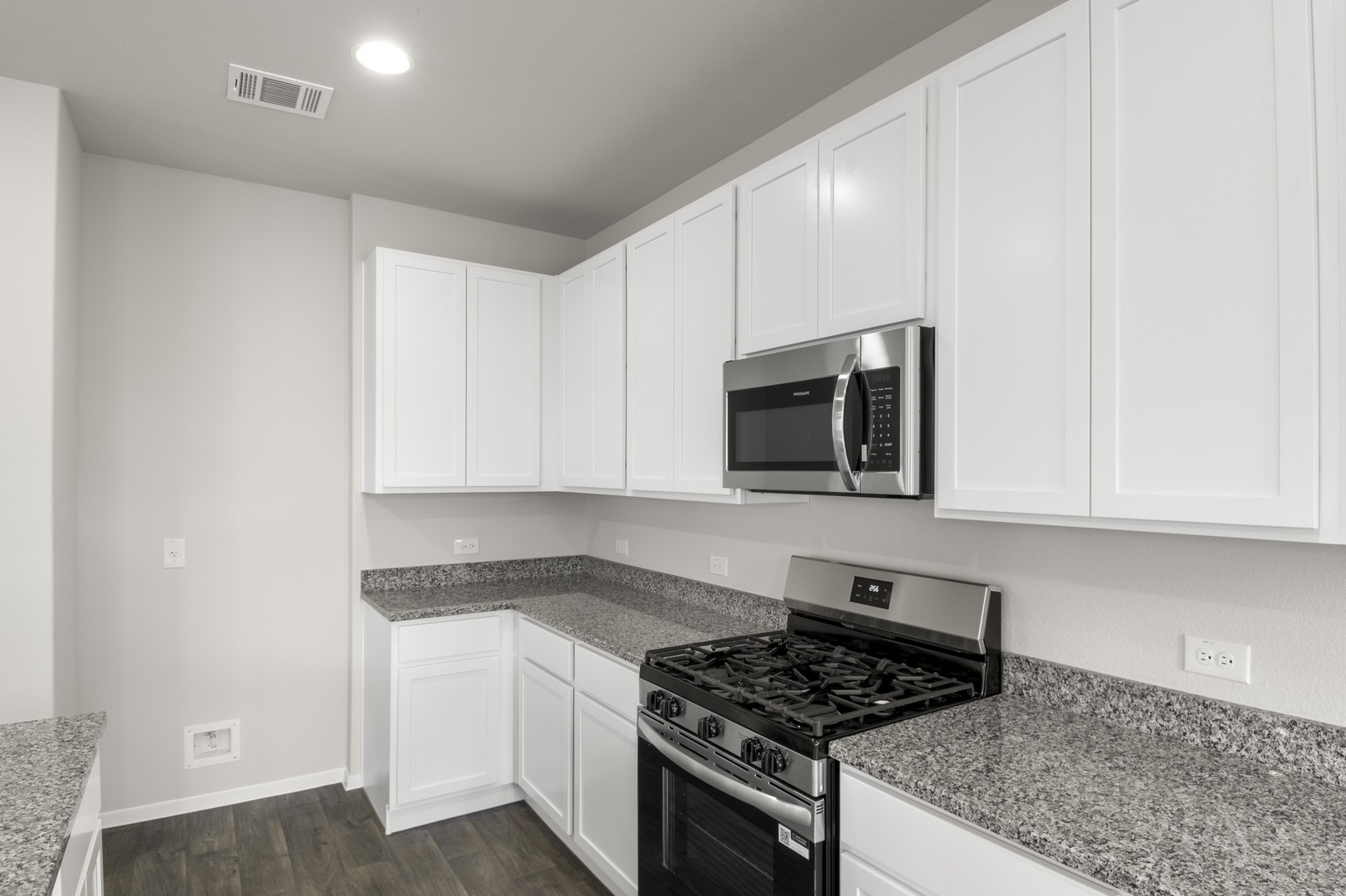 305 Jade Street Maxwell, TX 78656 - Photo 17 of 32 a kitchen with stainless steel appliances granite countertop white cabinets and a stove a oven with white countertops