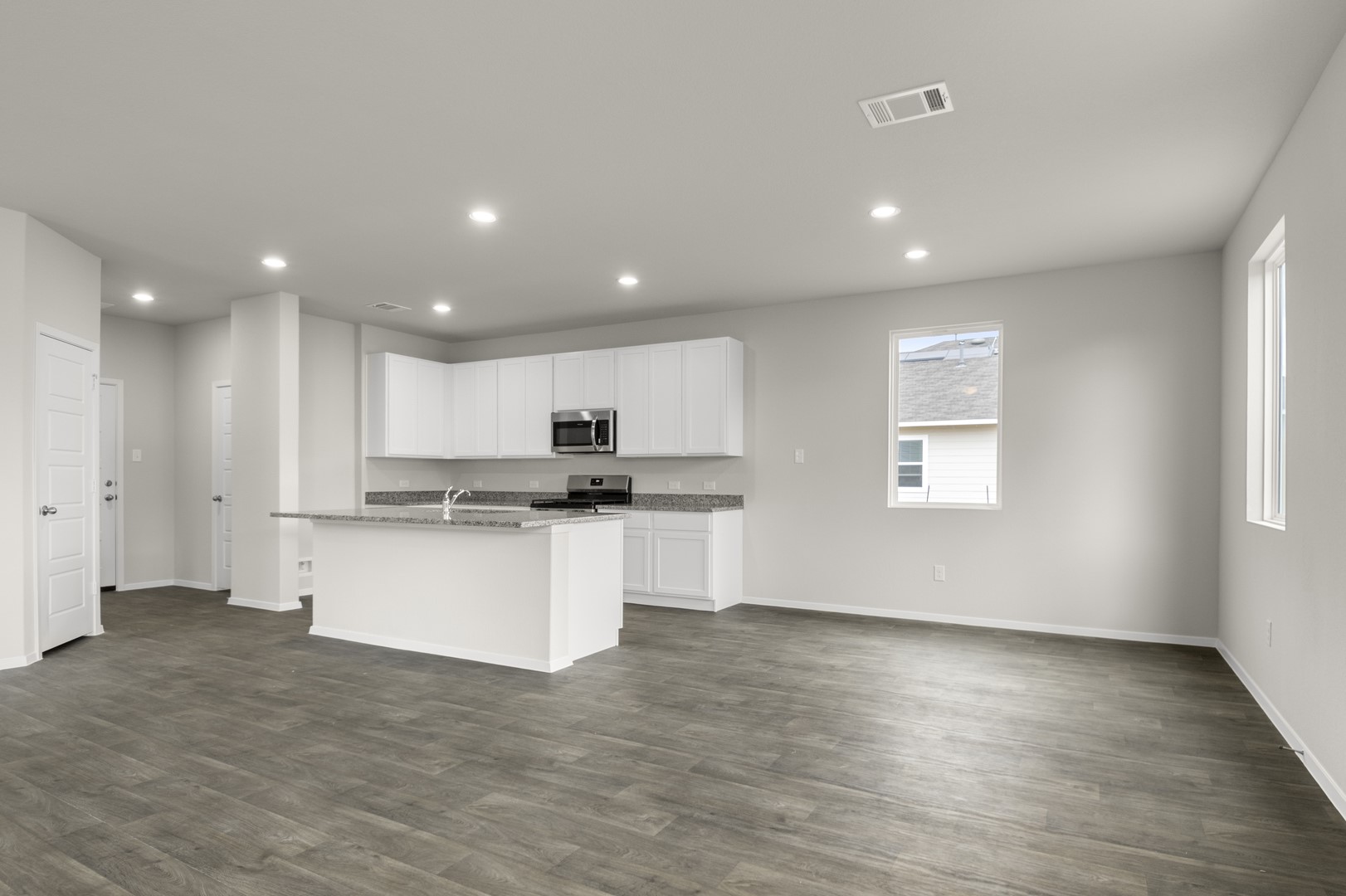 305 Jade Street Maxwell, TX 78656 - Photo 10 of 32 a open kitchen with white cabinets and wooden floor