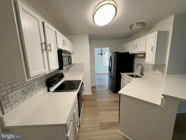 a kitchen with wooden cabinets and stainless steel appliances