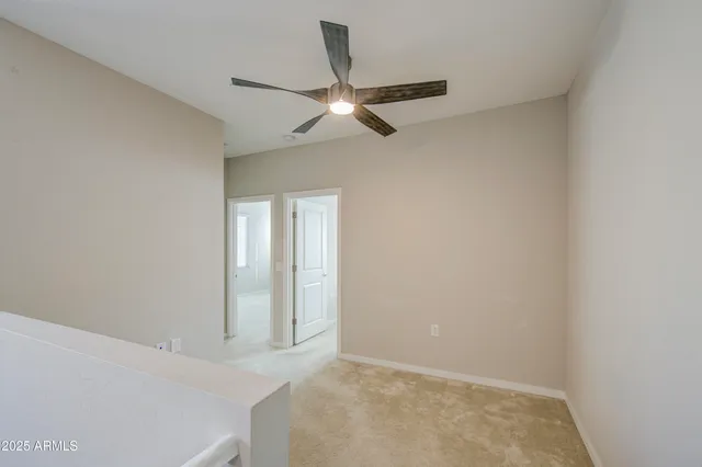 a bedroom with a bed a chandelier and a window