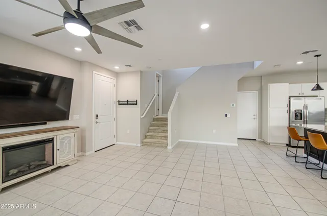 a kitchen with a sink white cabinets and stainless steel appliances