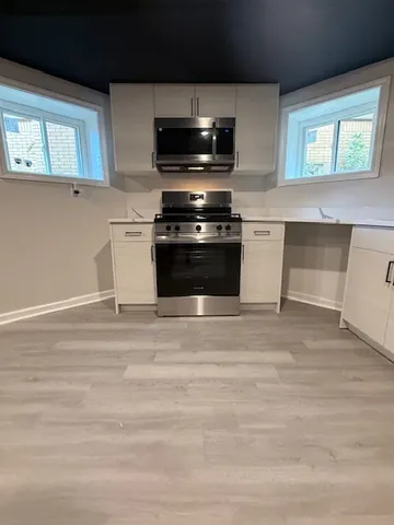 a view of a refrigerator in kitchen and window